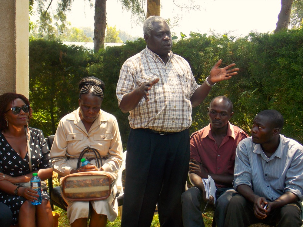 Discussion group of men and women outside health centre in Kenya.
