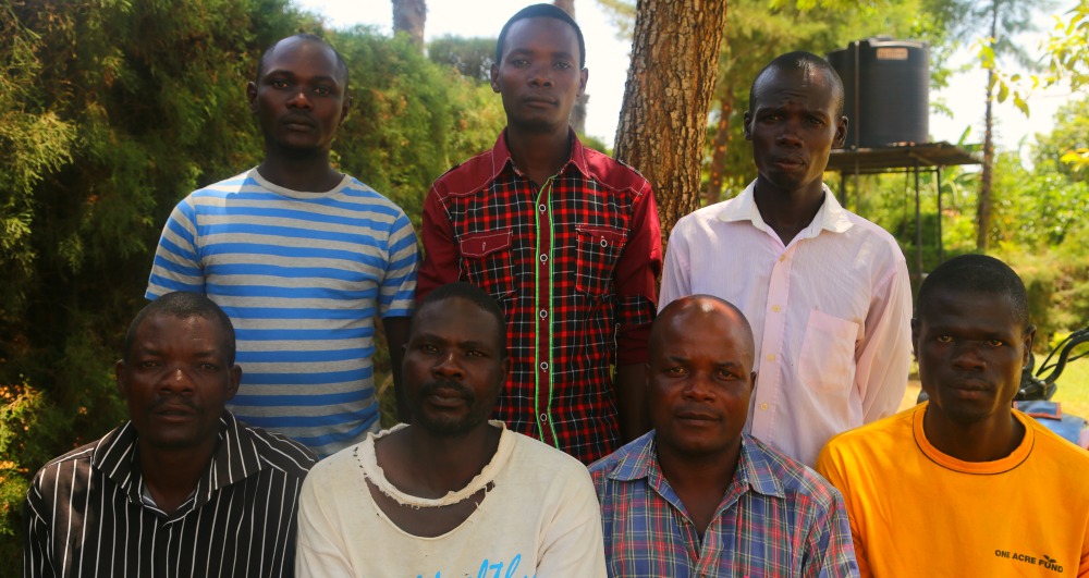 Group of fathers sit outside health centre in Kenya.