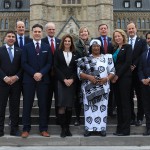Nutrition International board members pose in front of the Parliament building.