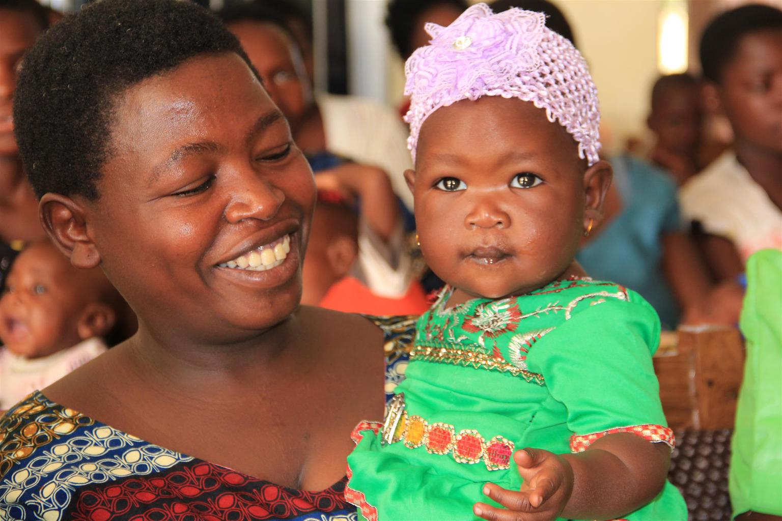 Photo of a smiling mother holding her daughter in Tanzania
