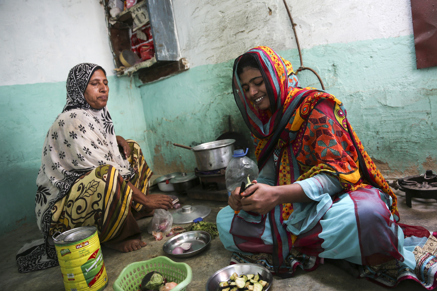 Pakistani women making food together.