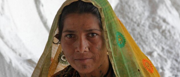 woman in gujarat in front of salt pile