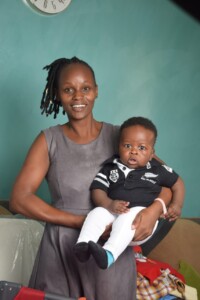 Mom holding her son smiling to camera