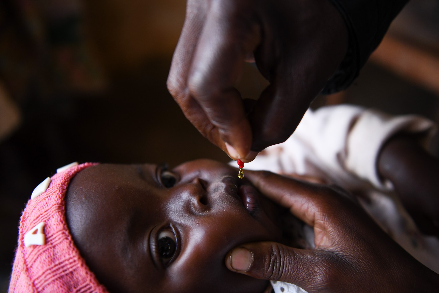 Close up image of an infant receiving a droplet of a vitamin A dose