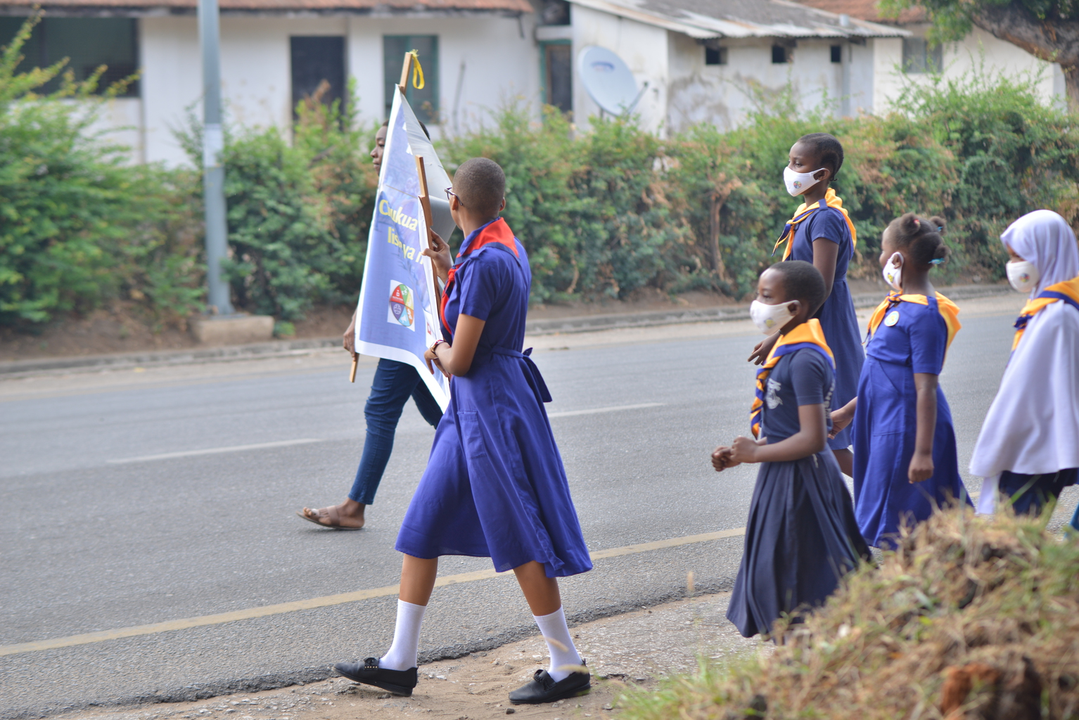 Girls marching in an awareness walk in Tanzania to raise awareness around adolescent nutrition. 