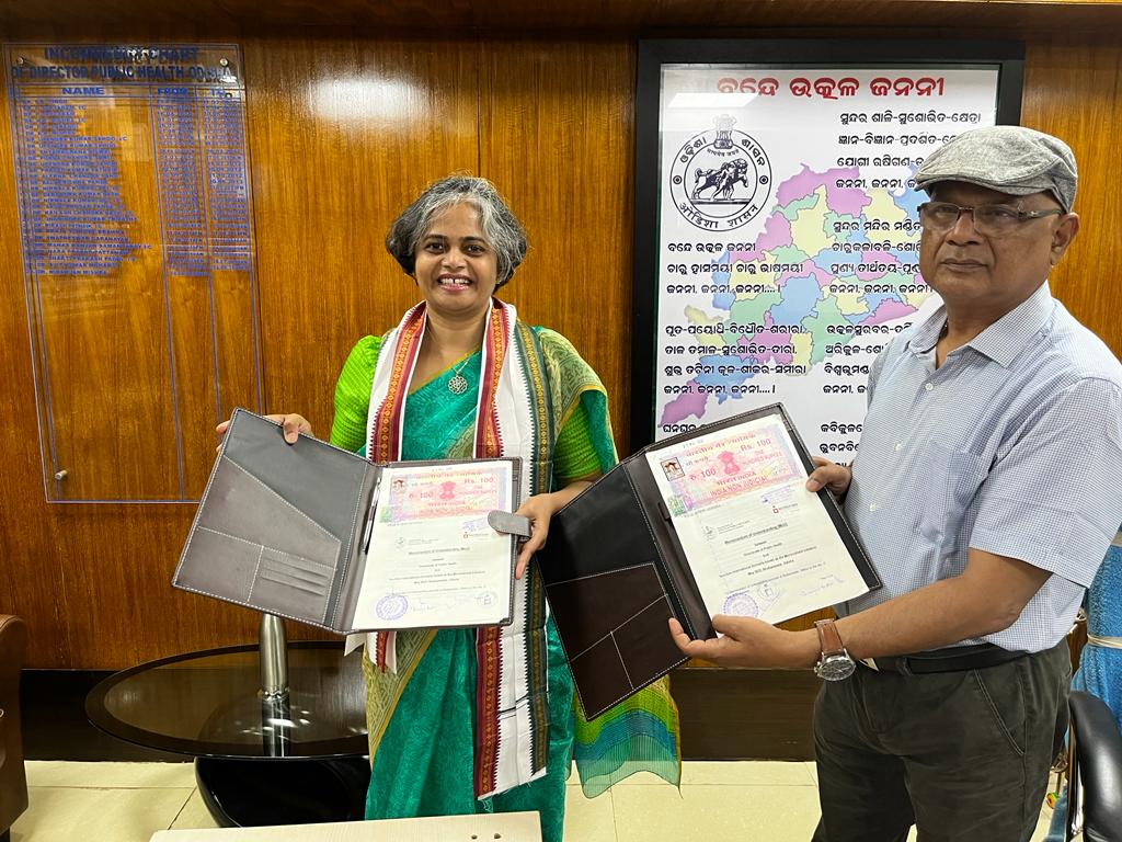 Nutrition International country director and Odisha director of public health hold up the signed MOUs