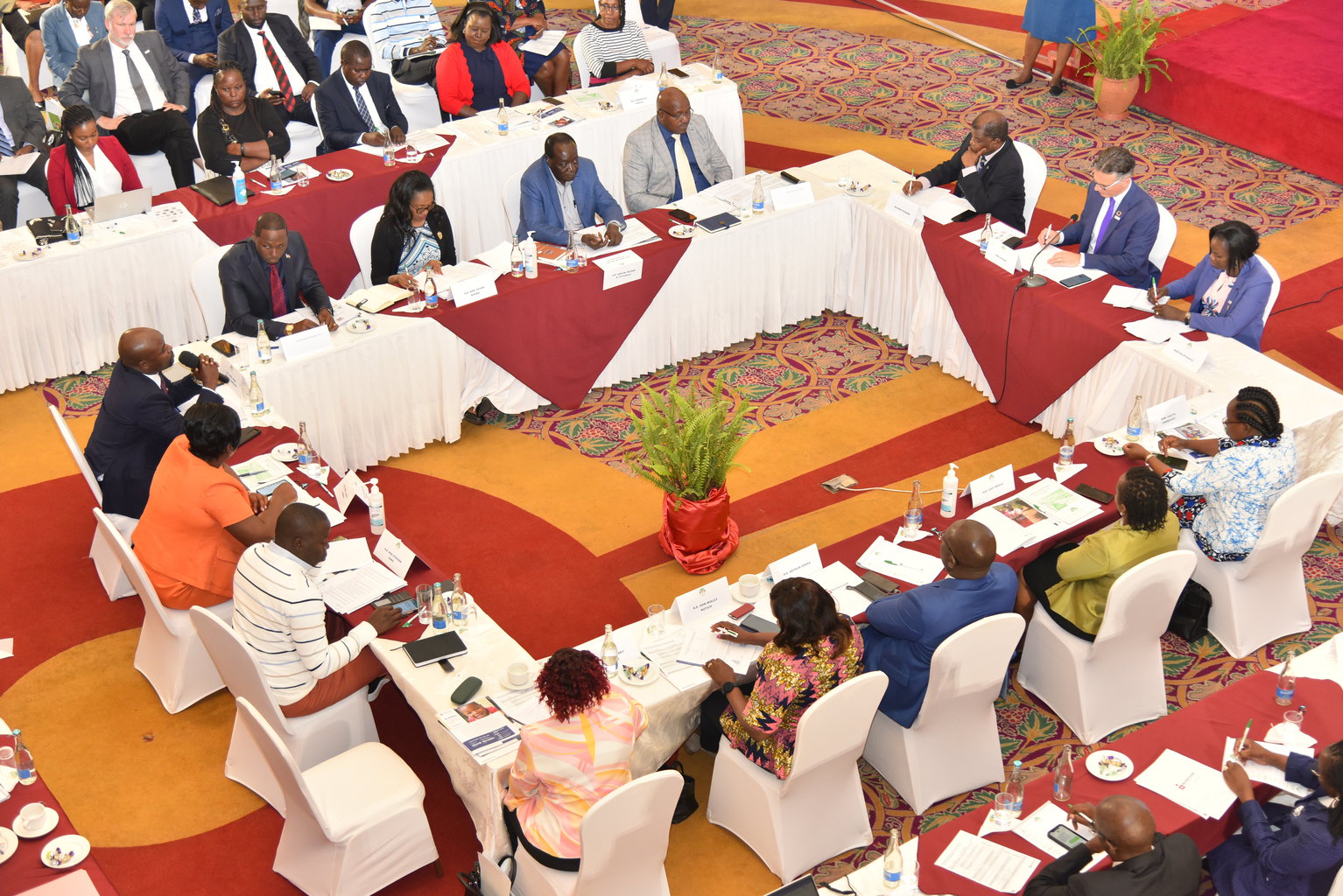 Group of people sitting at a table signing a document