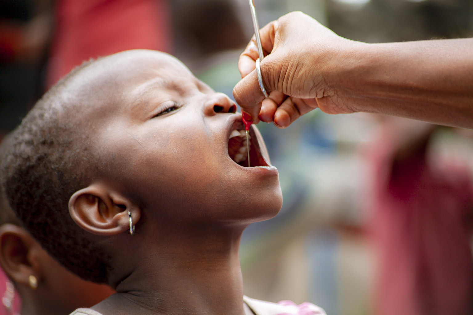 a young girl receives a dose of vitamine A