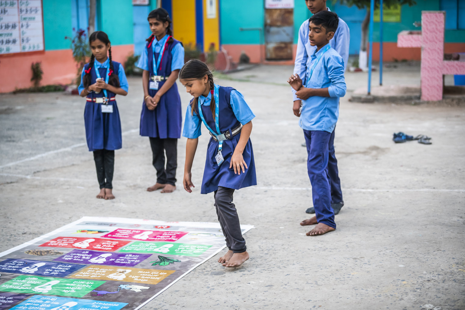 A group of students play a game in the schoolyard