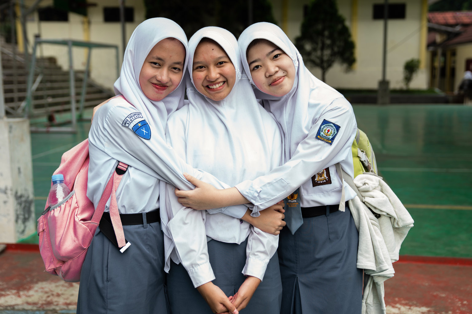 Three Indonesian girls hug