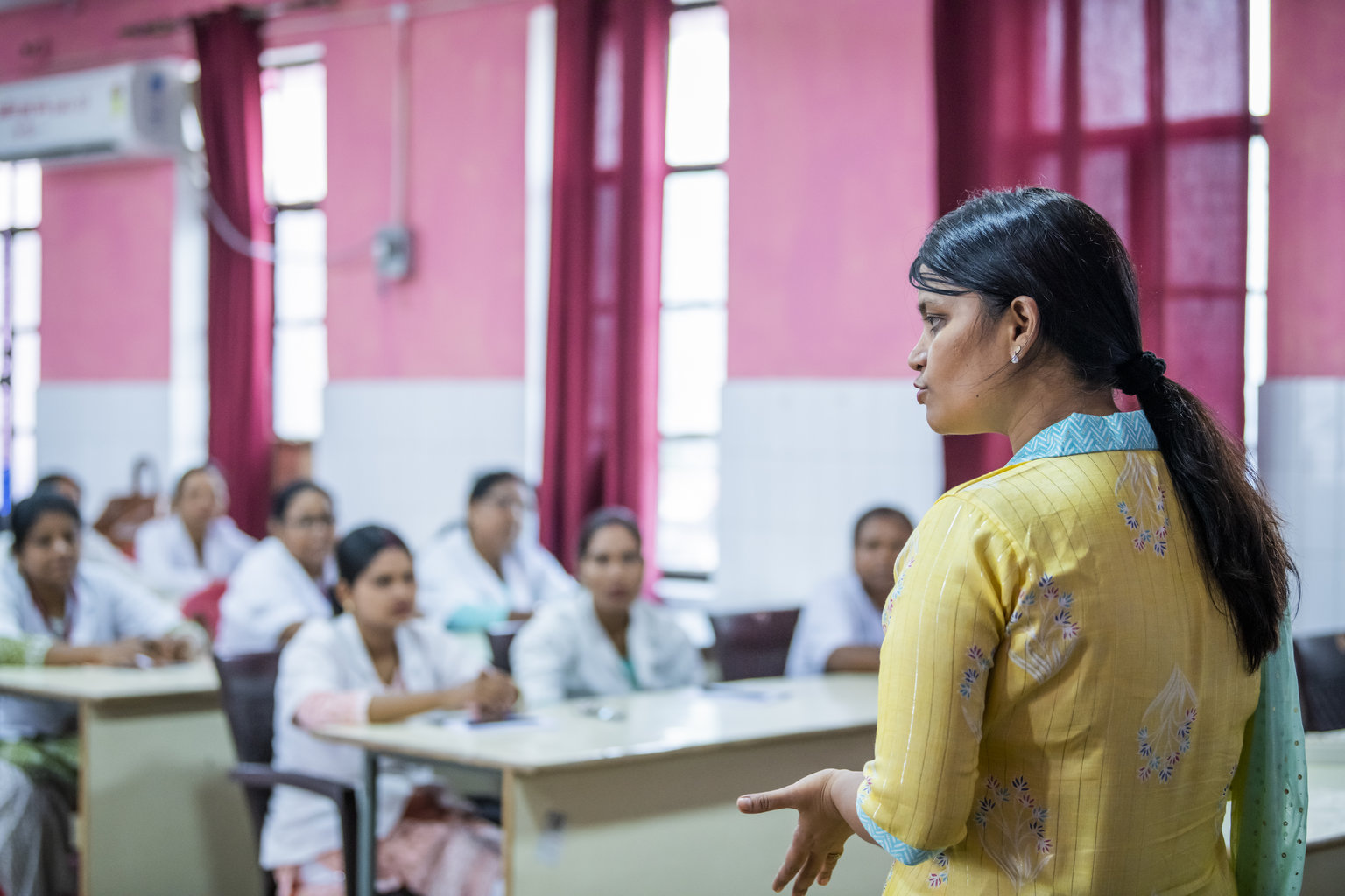 A doctor presents to a group of health workers at a hospital in India