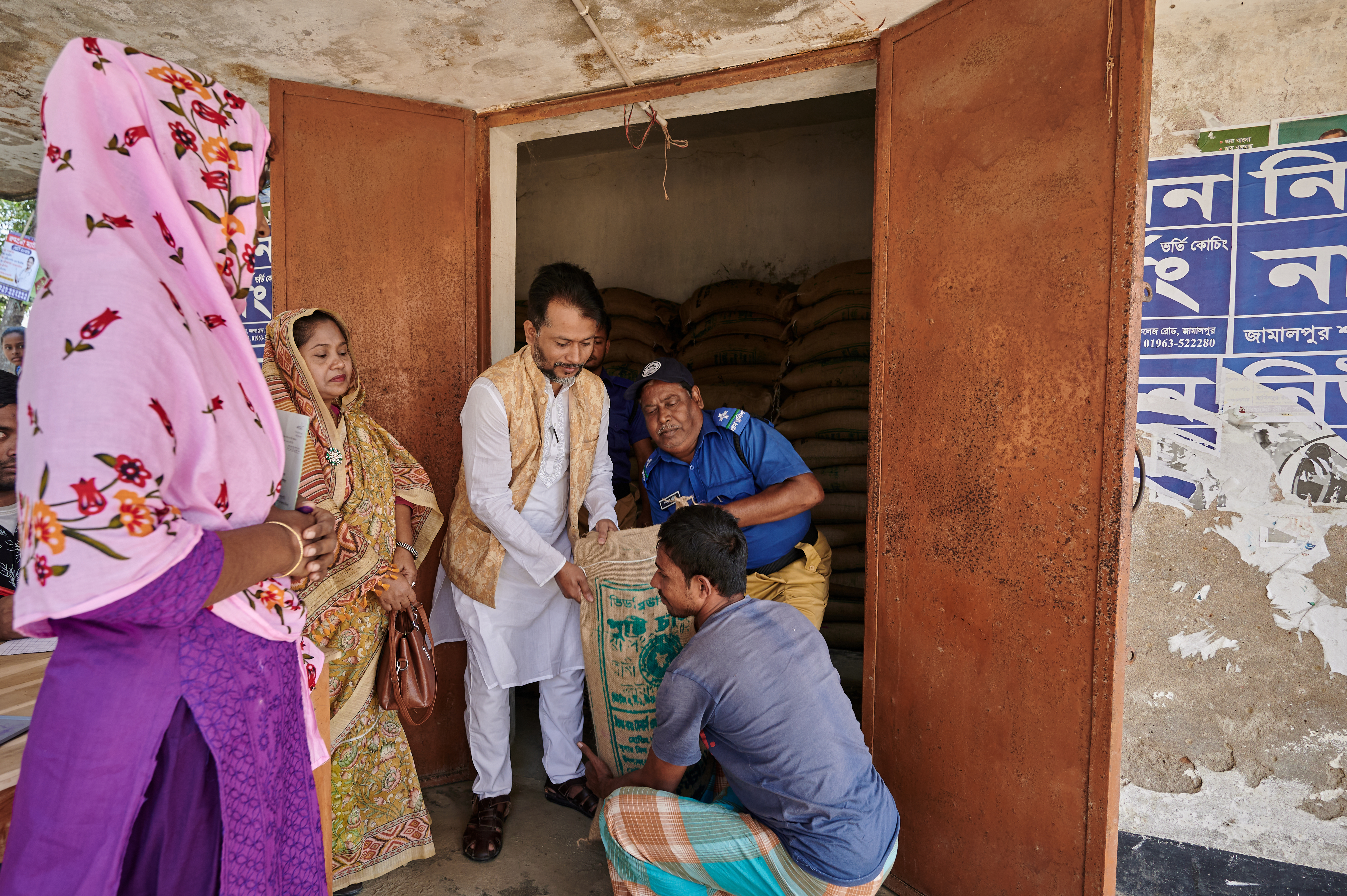 A card holder of the Vulnerable Women Benefit SSNP and is collecting her rice fortified with micronutrients from the distribution point.