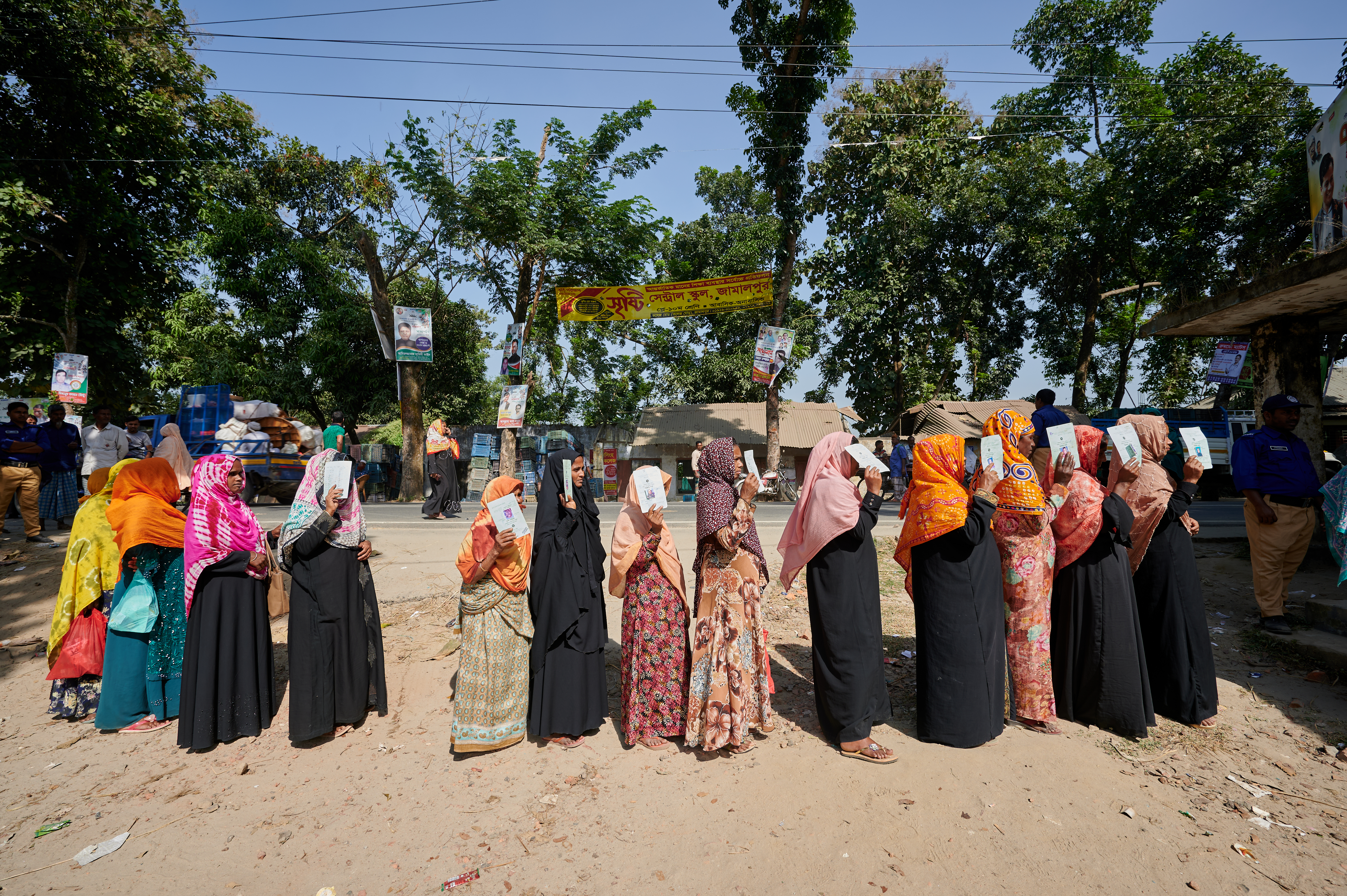 Women line up at a distribution point in Jamalpur District in Bangladesh to collect their packages of fortified rice.