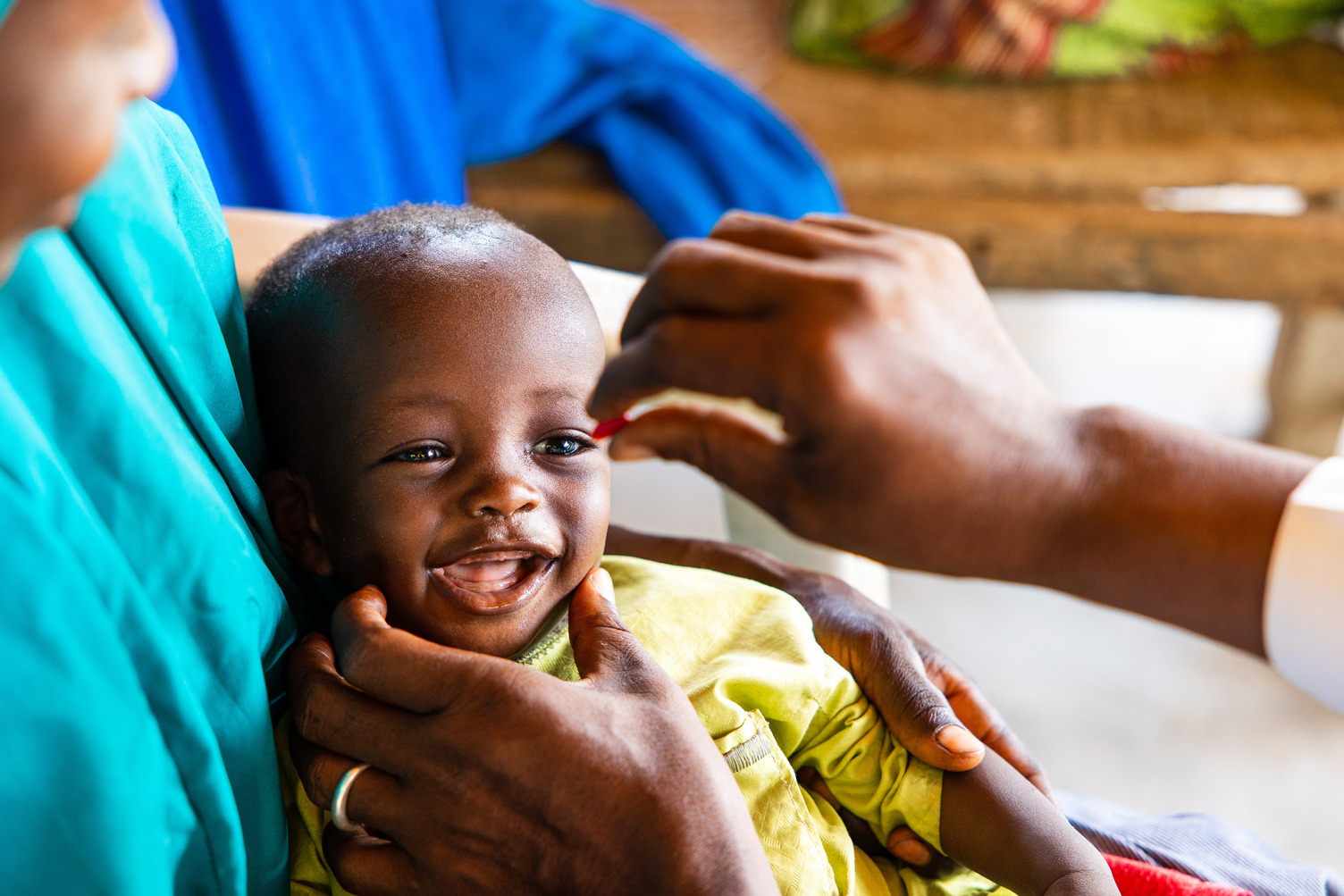 Baby smiling while receiving vitamin A capsule