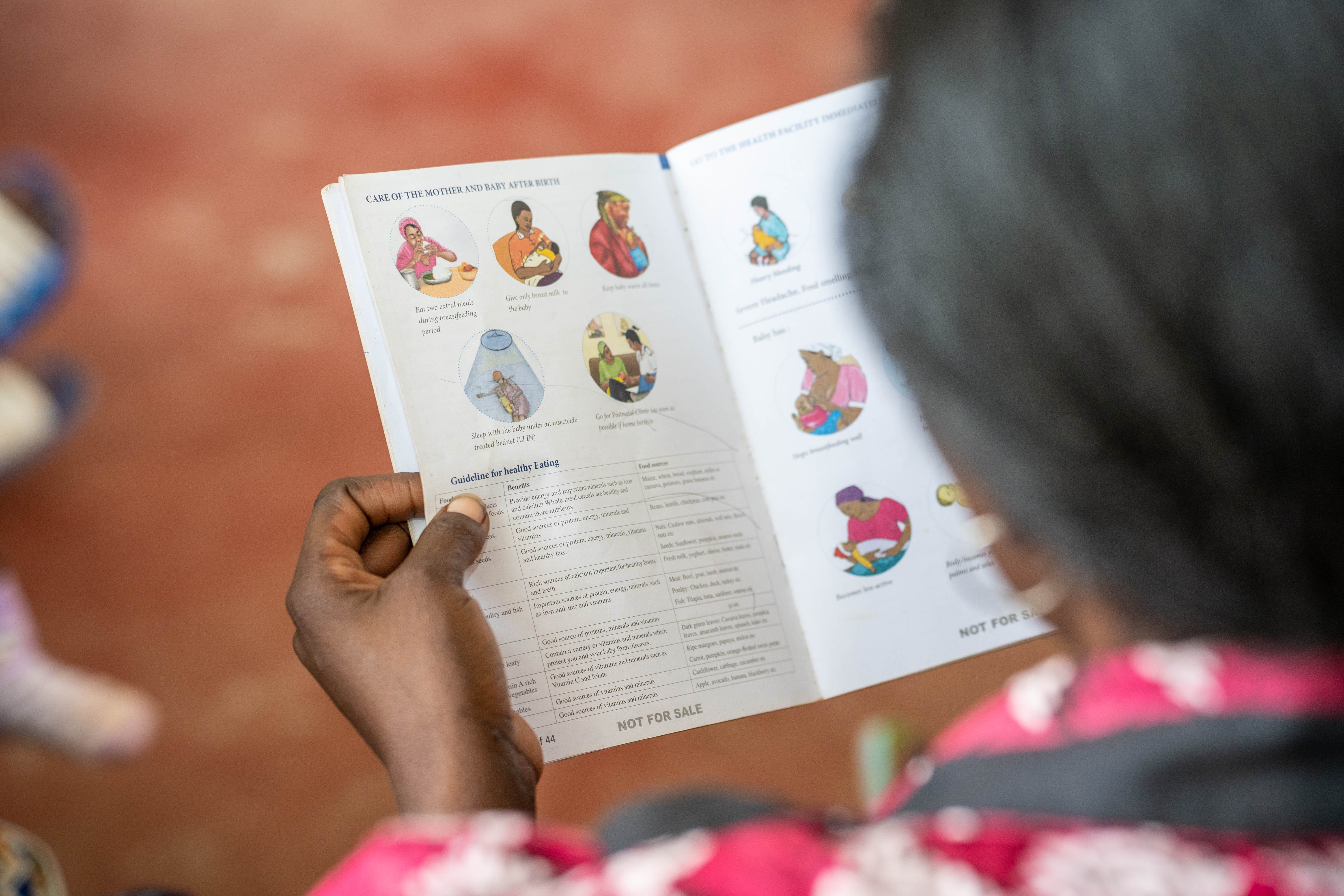 A woman reads an informational pamphlet