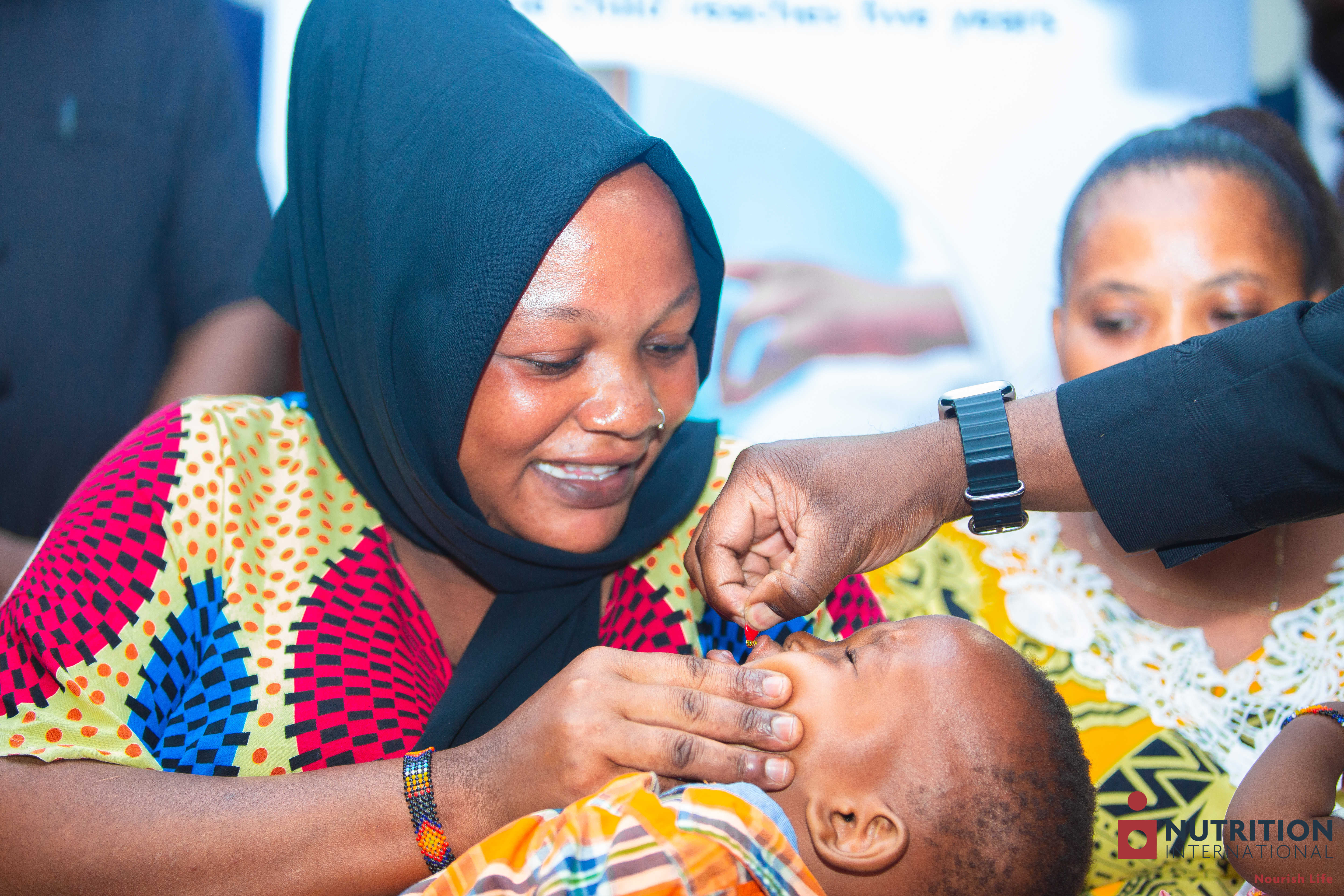 A child being held in its mother's arms