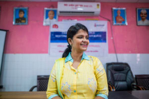 Dr. Shikha Sachan standing at front of classroom leading an education session.