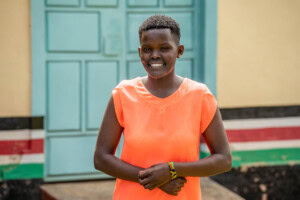 Sherry, standing and smiling at the camera