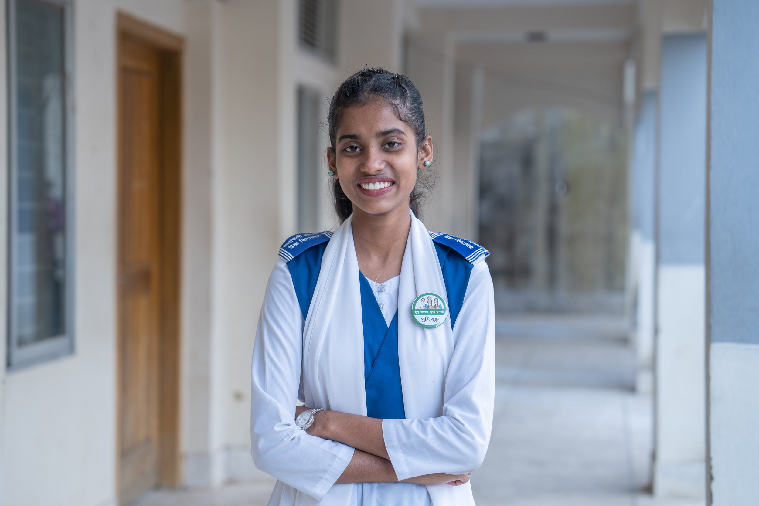 A students stands infront of her classroom